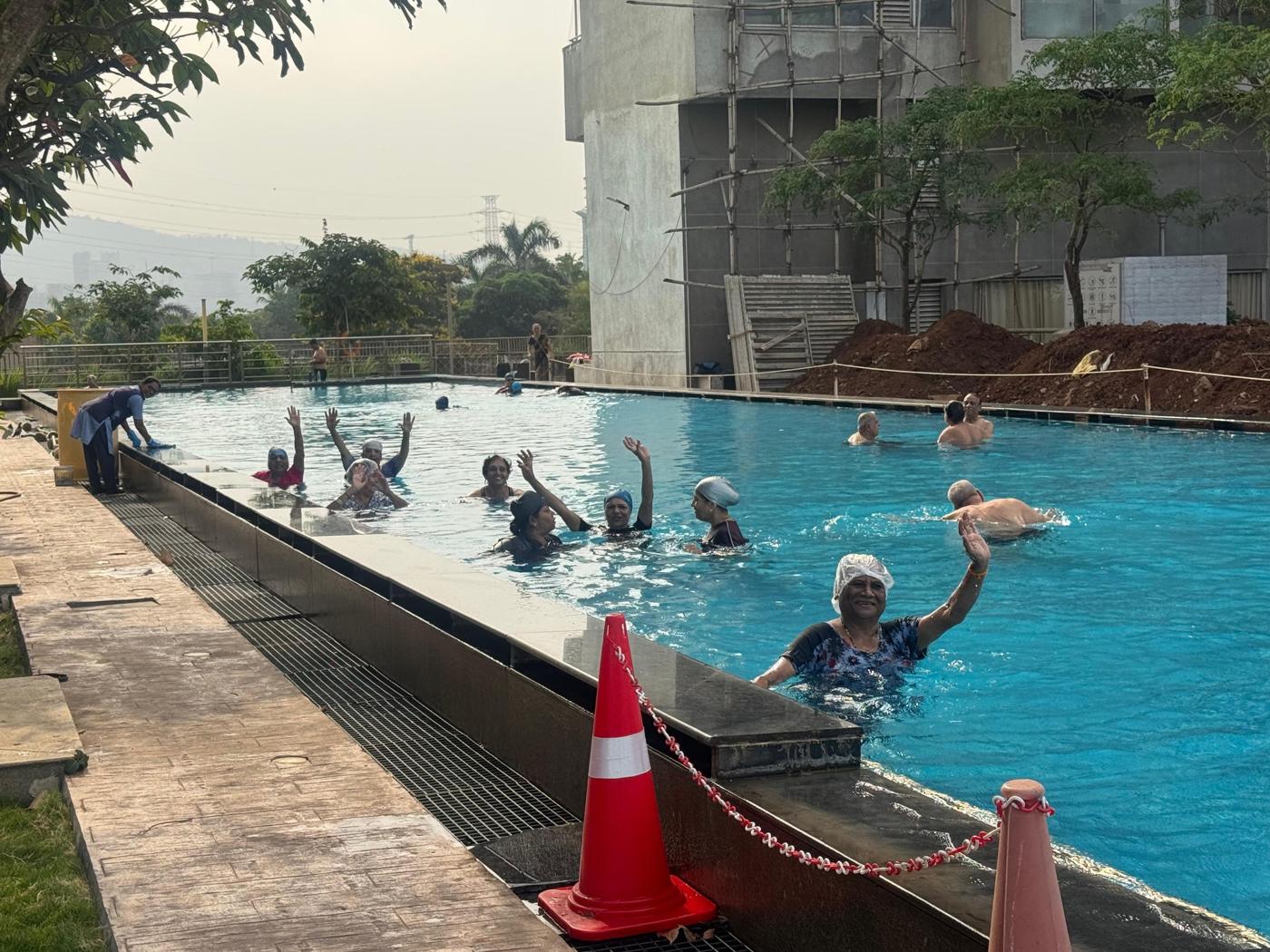 Residents waving from the pool at a pool party at Palm Beach Residency, Navi Mumbai